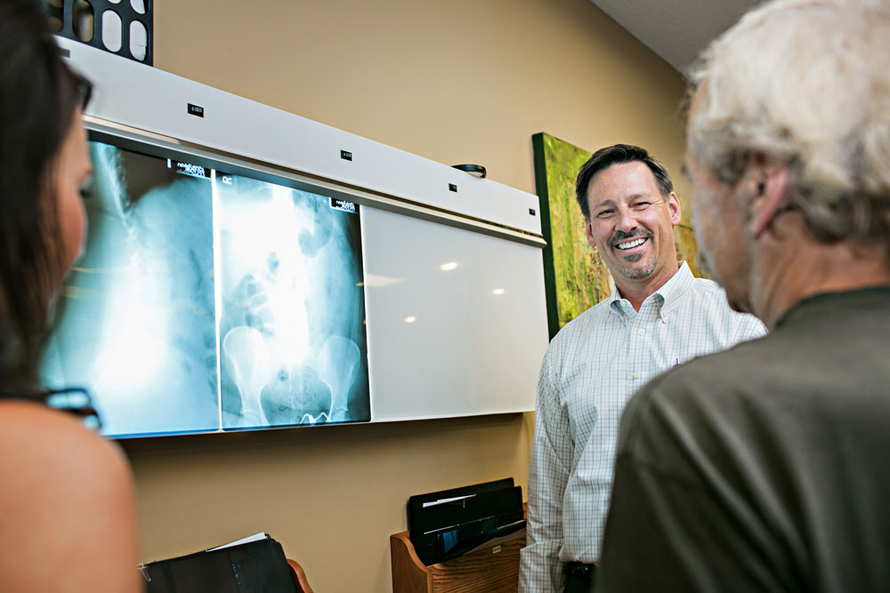 Dr. Harder looking at x-ray with patient