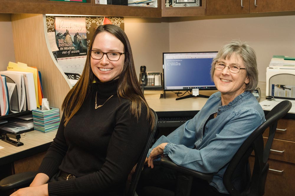Smiling woman sitting at a desk