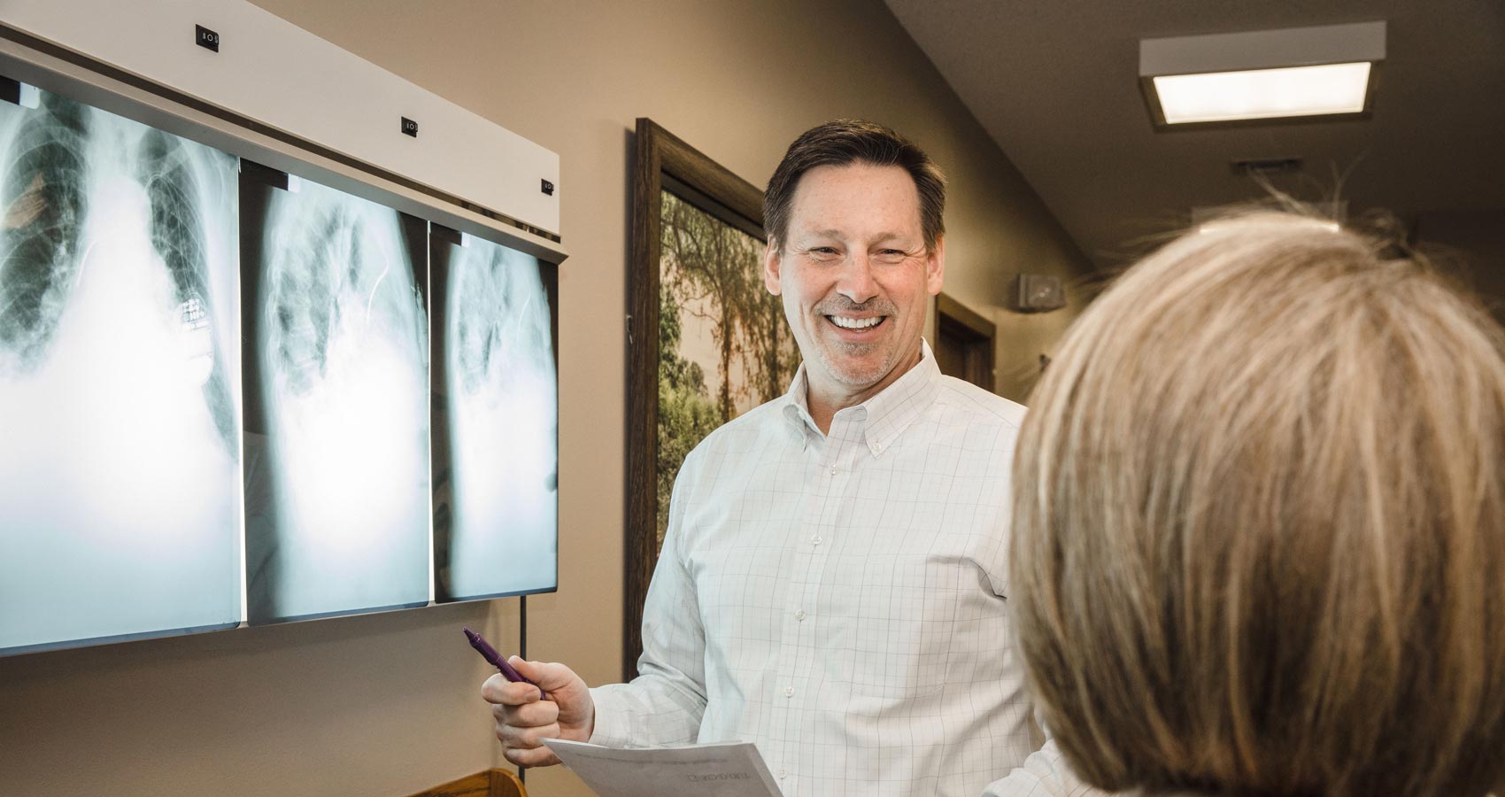 Dr. Harder looking at x-ray with patient